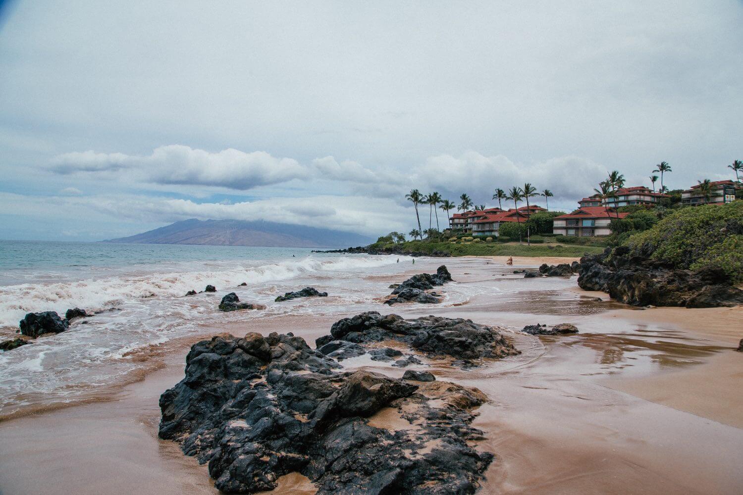 Best Maui Beaches Polo Beach Rocks on the sand with the waves flowing over them