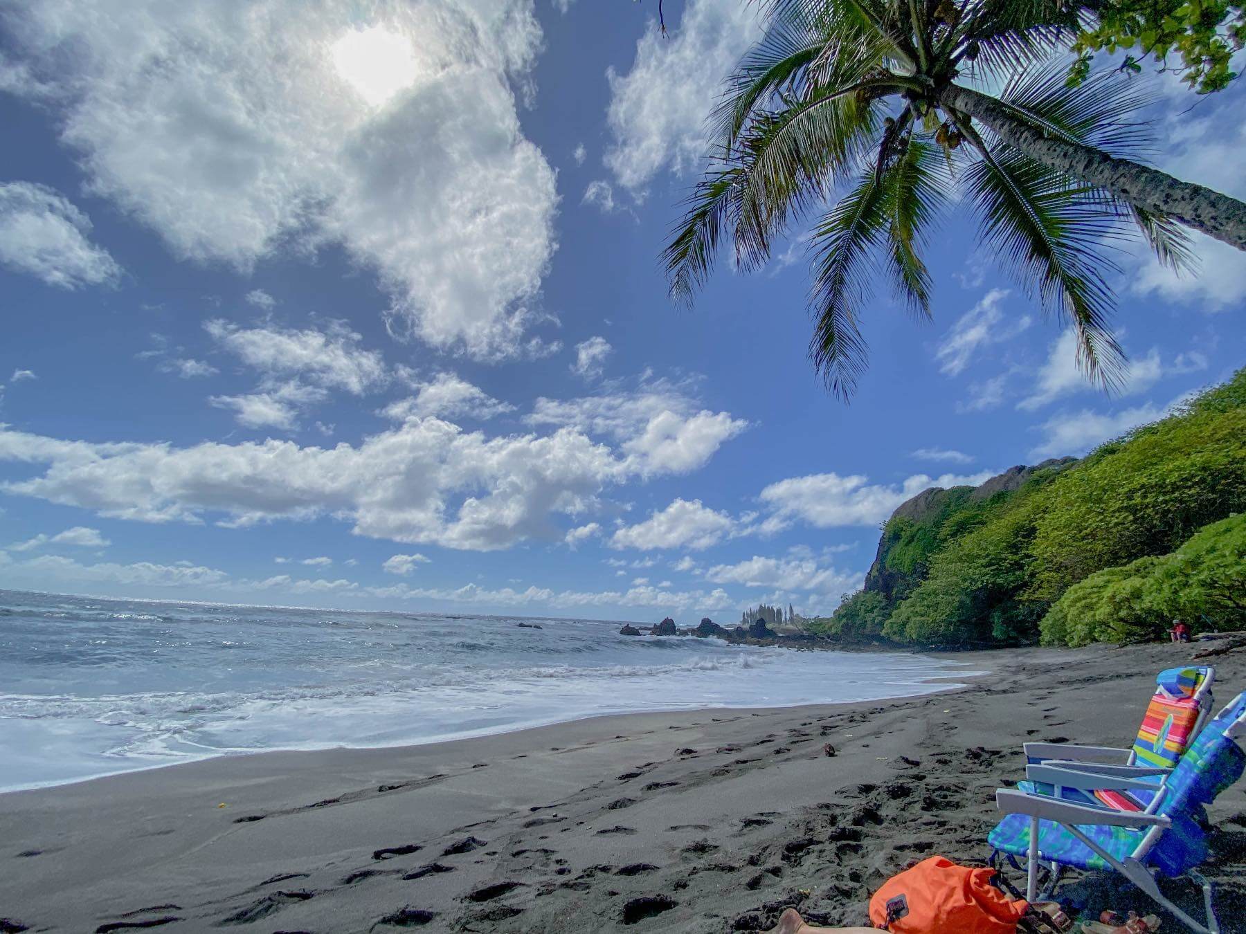 Hamoa Beach Hana HI. Things to do-2 Beach chairs on a beach with a palm tree on Maui