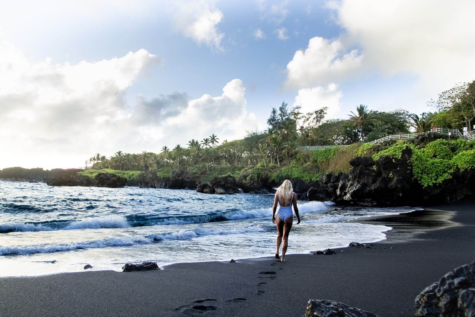 I'm Jess Traveling on a black sand beach in Maui