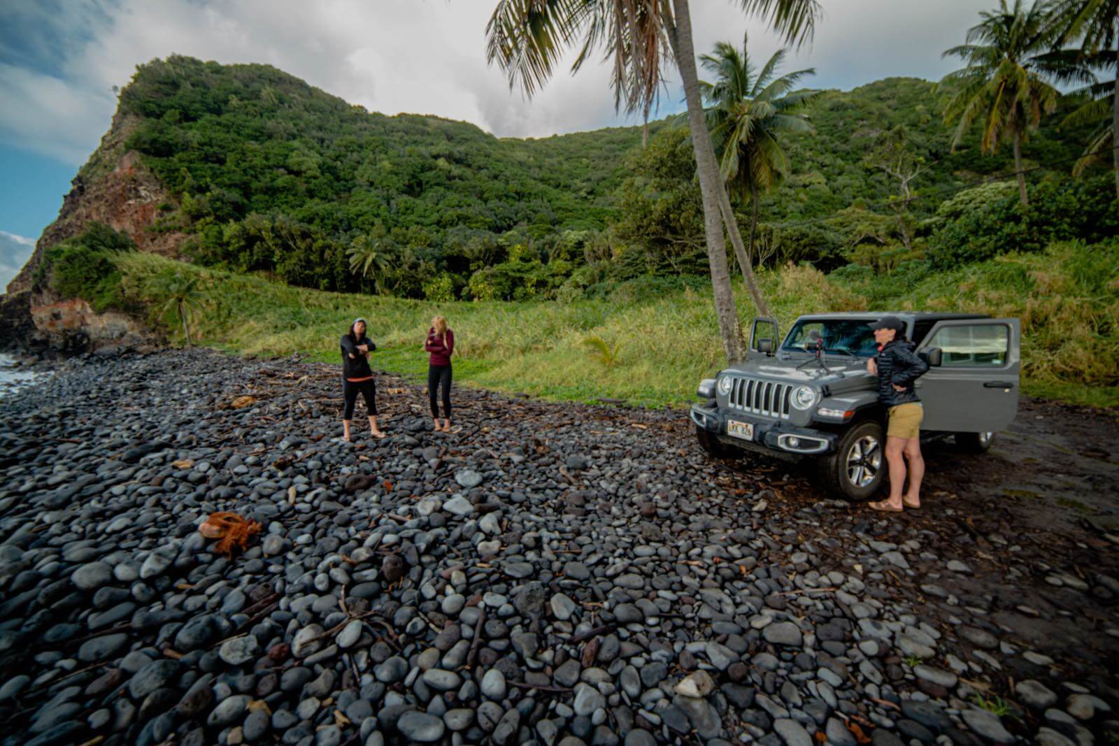 Jeep on a black rock beach on Maui