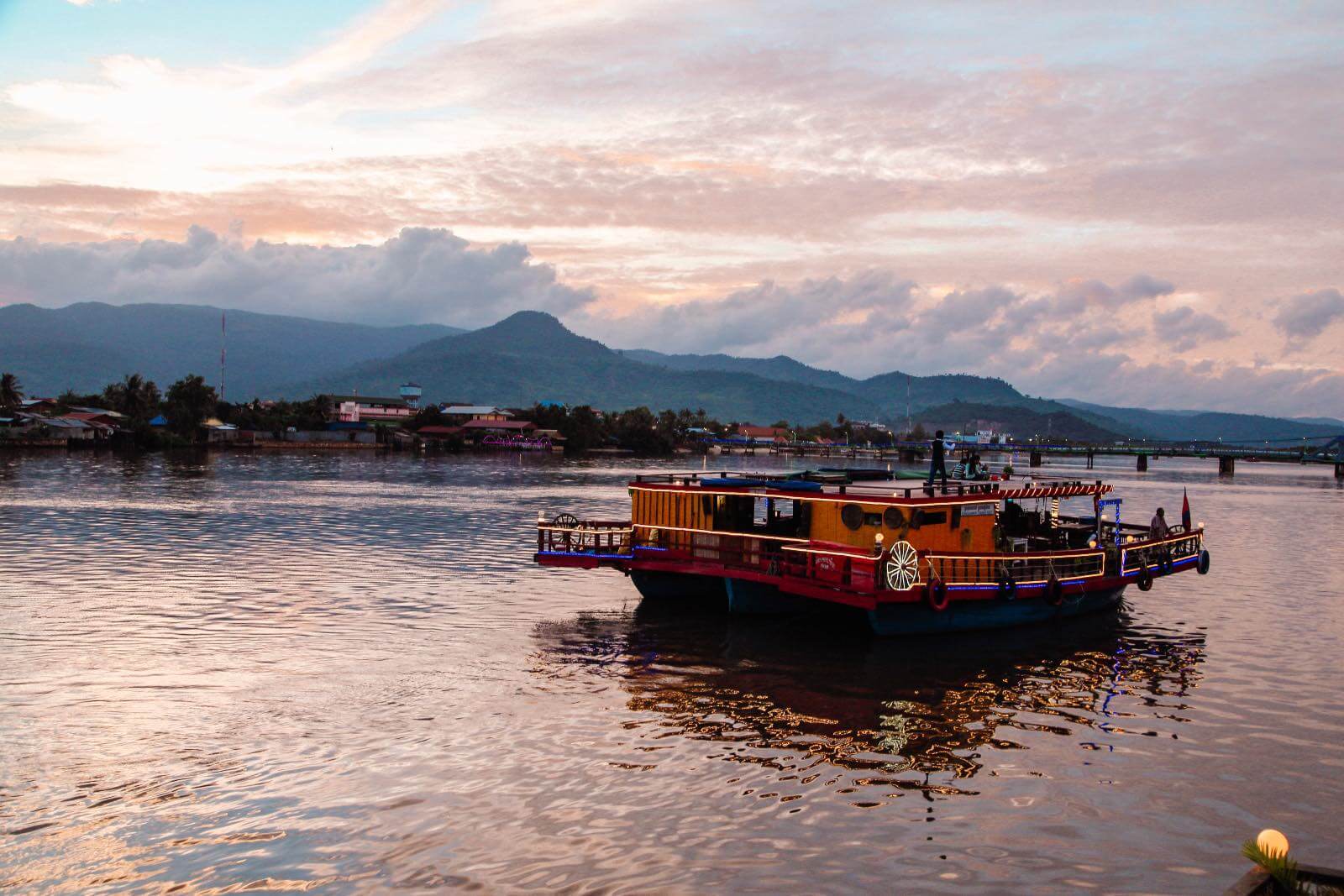 Boat floating on the Kampot river at sunset