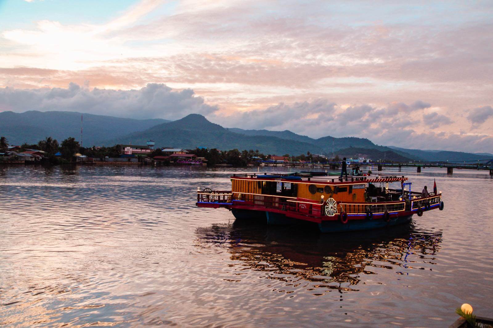 Kampot Cambodia Boat floating on the Kampot river at sunset