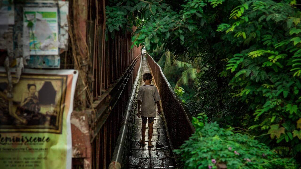 Luang Prabang, Laos Boy on a bridge in Luang Prabang Laos