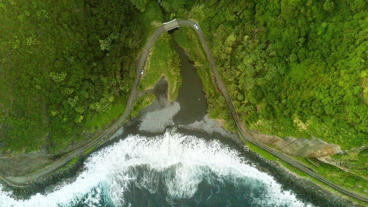 Lush Maui from above with waves crashing into the shore