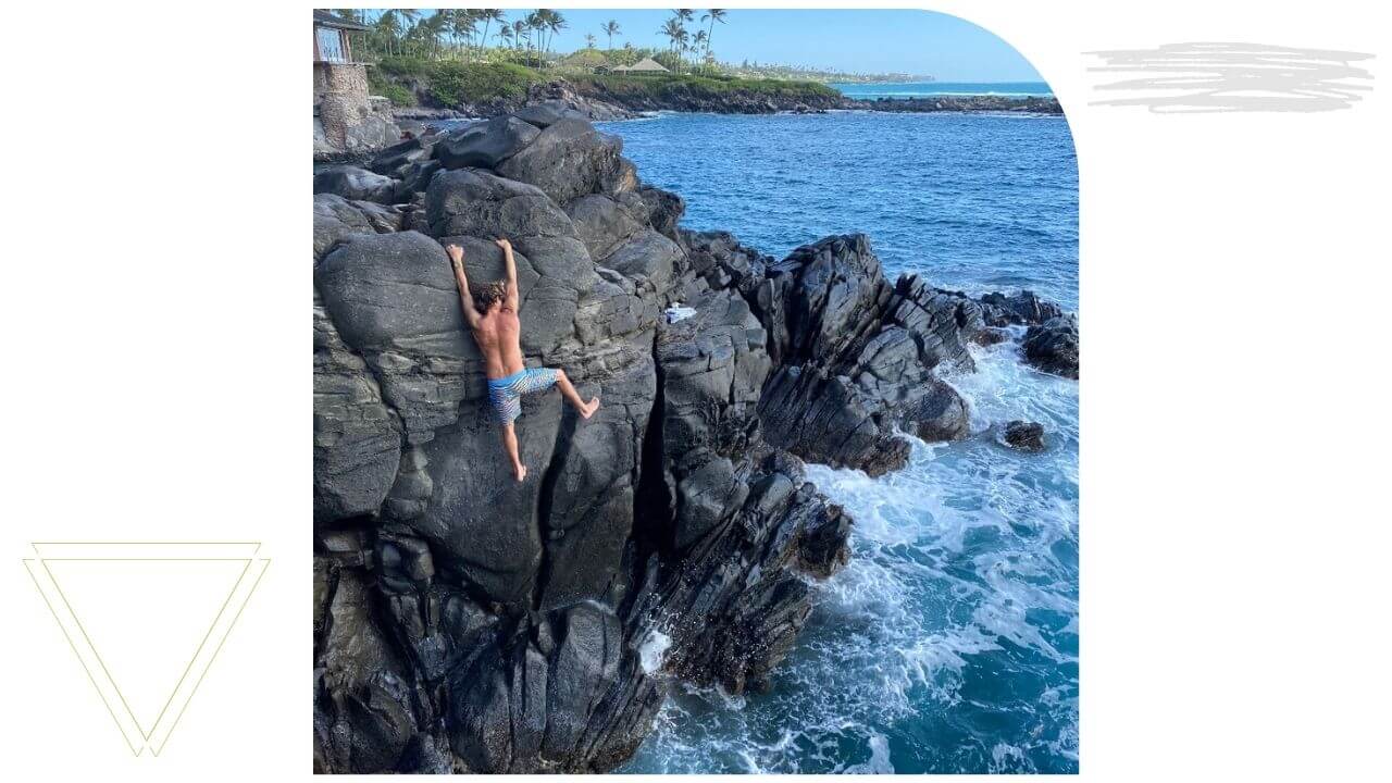 Cliff Jumping at Cliff House on Maui Man climbing up a cliff in West Maui