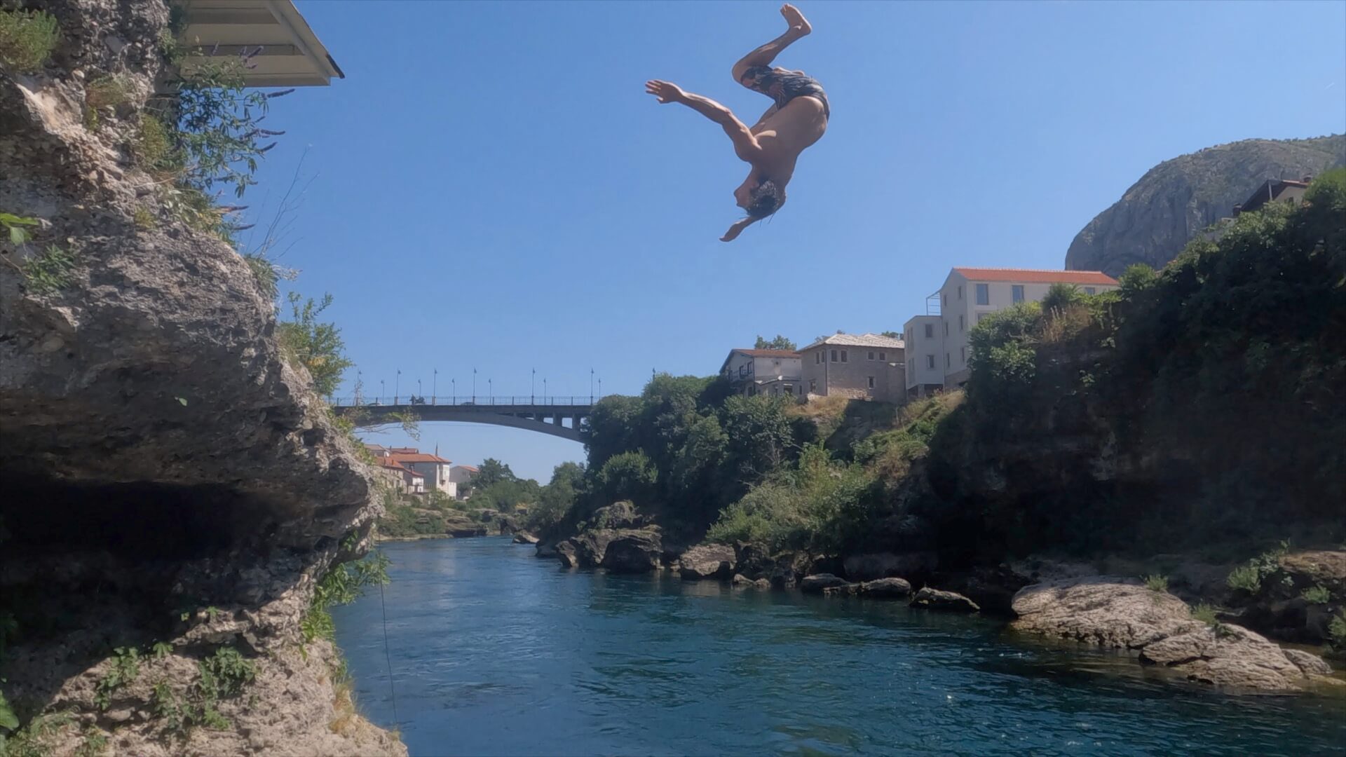 Jumping off a platform into the river in Mostar