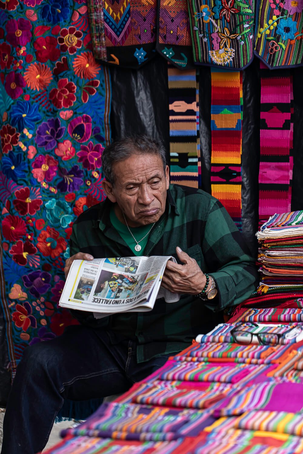 A man reading the newspaper at the Chichicastenango Market
